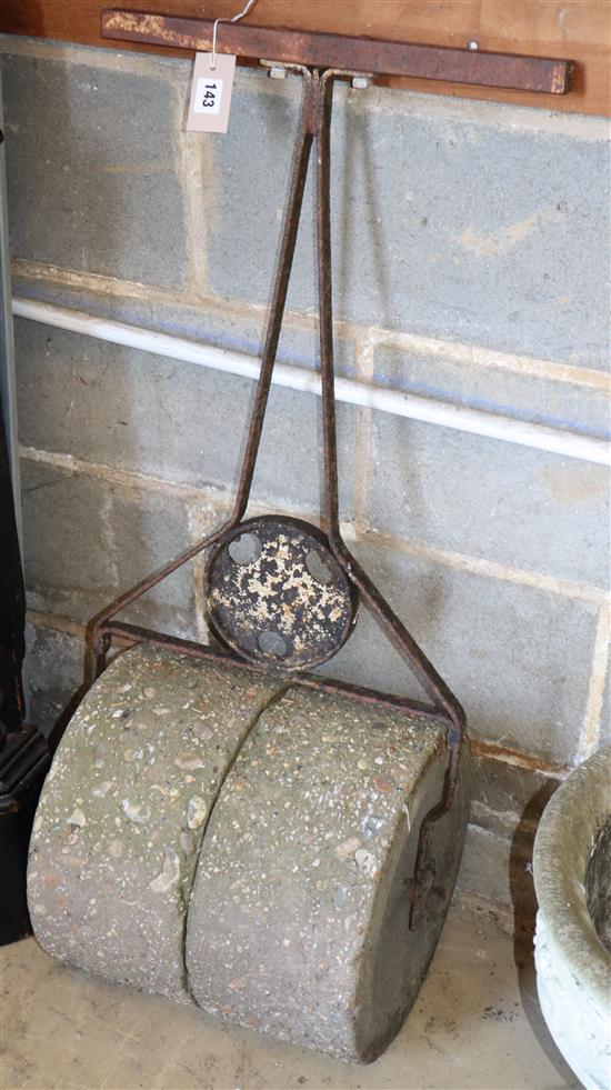 A wrought iron and concrete garden roller, W.40cm D.36cm H.100cm